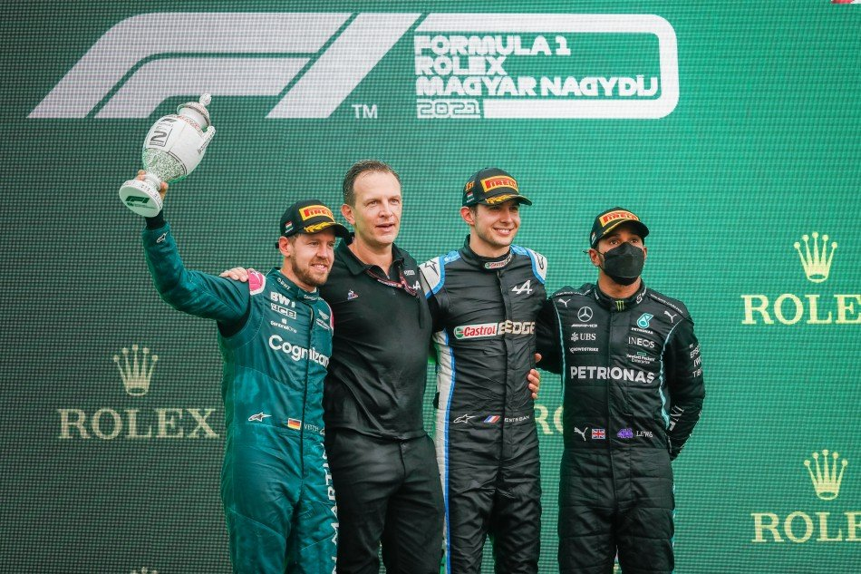 Estaban Ocon wśród Sebastiana Vettela i Lewisa Hamiltona na podium po Grand Prix Węgrzech 2021, w którym wywalczył sobie zwycięstwo.